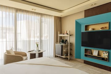 a room with a bed and a tv