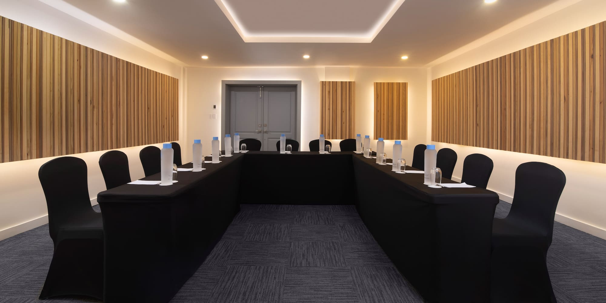 a room with black tables and chairs