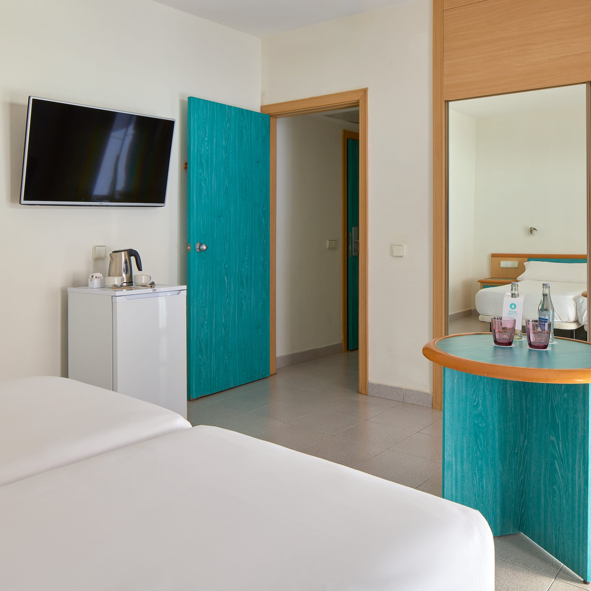 a room with a bed and a television