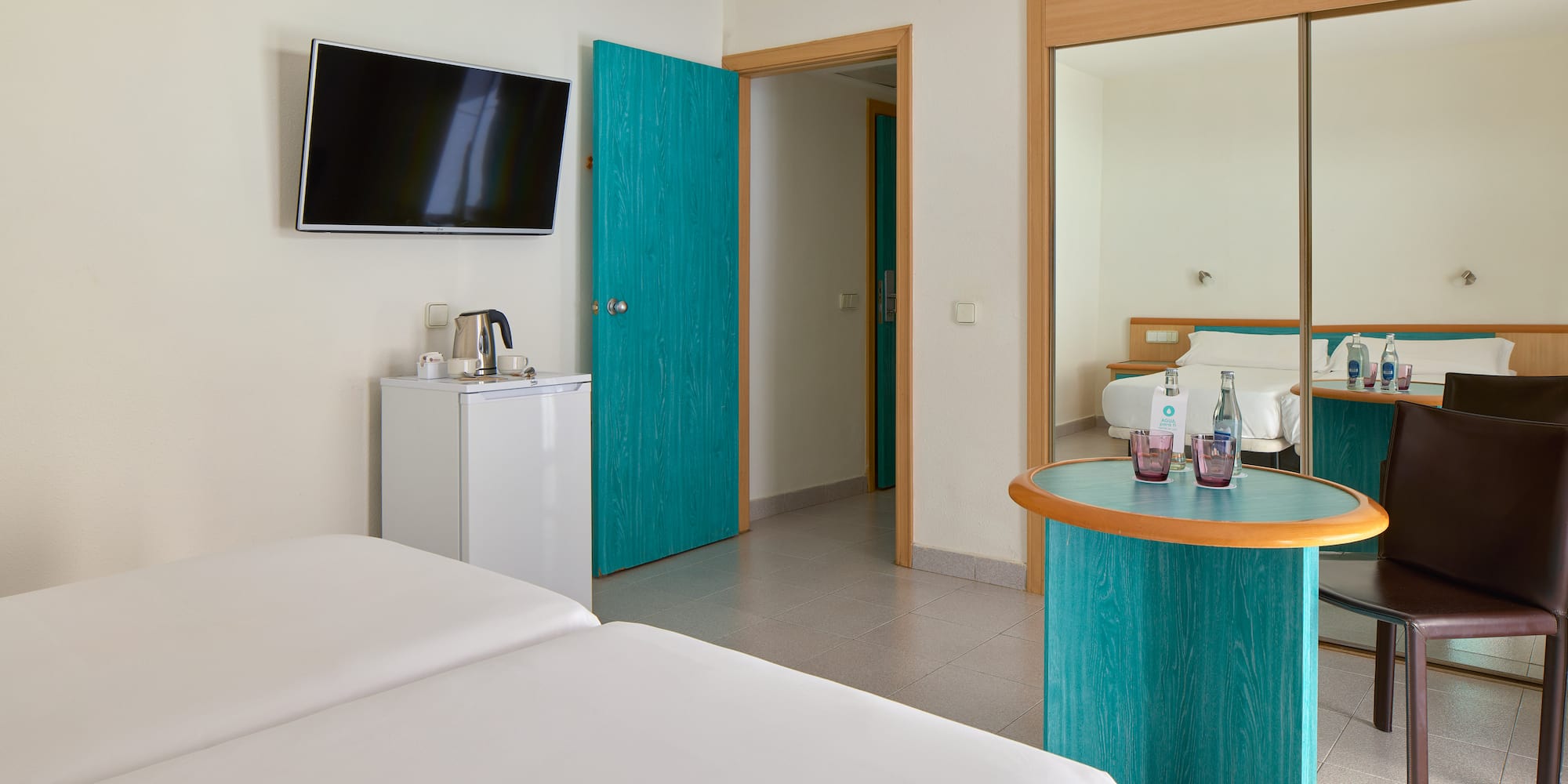 a room with a bed and a television