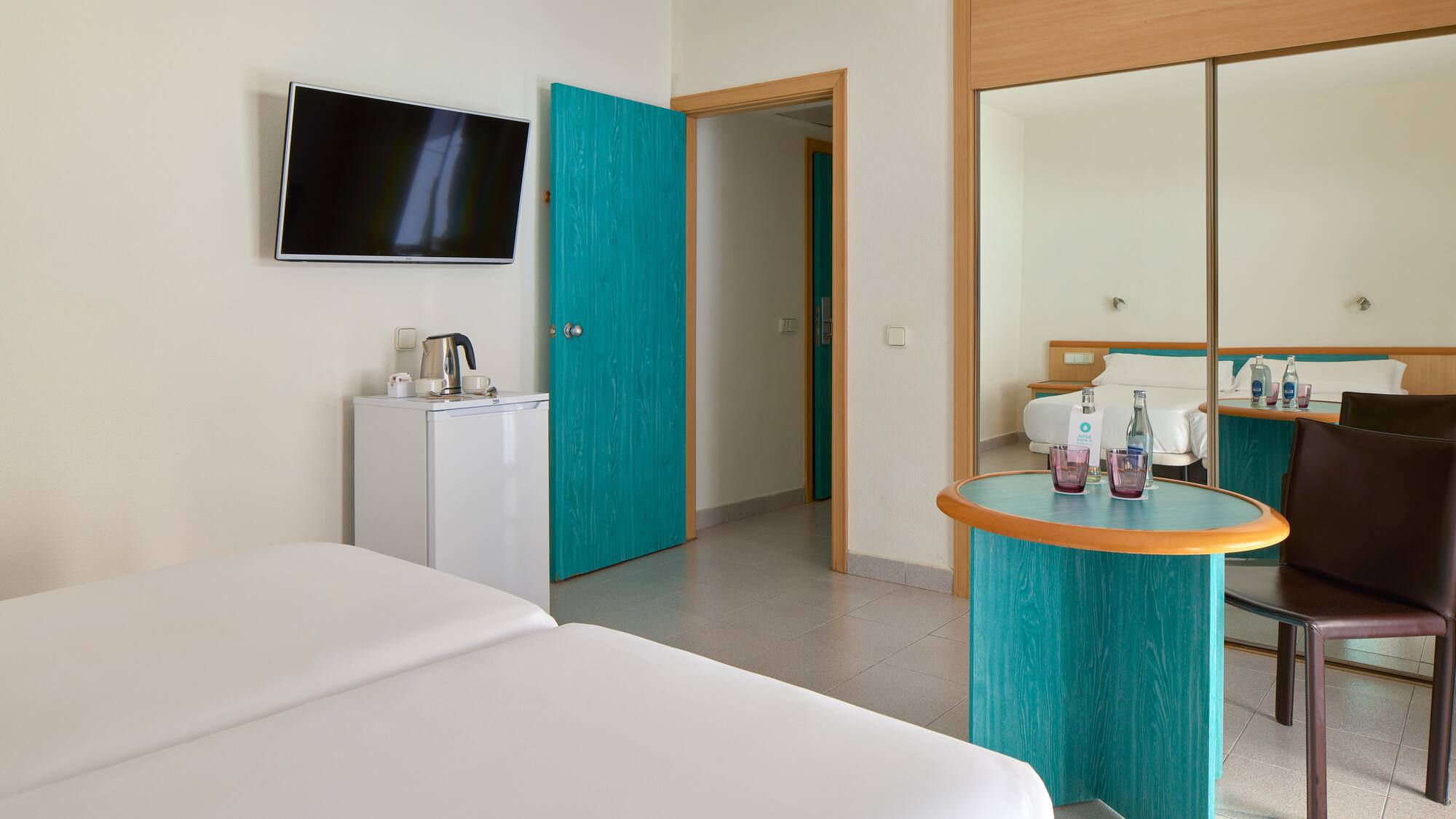 a room with a bed and a television