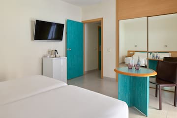 a room with a bed and a television