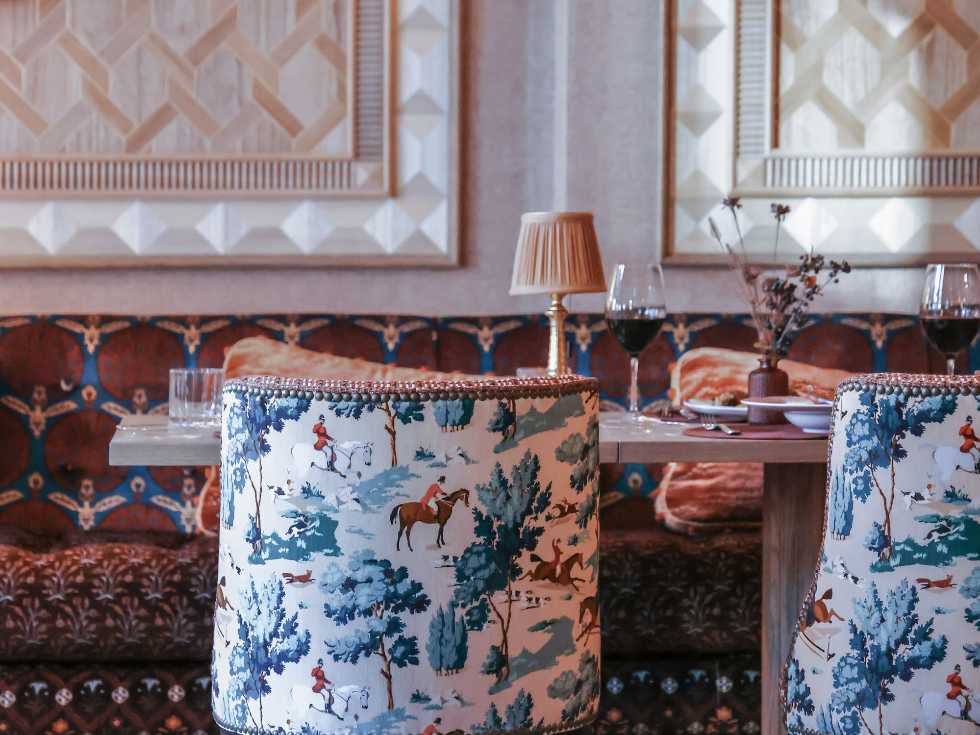 a table with chairs and a table with wine glasses