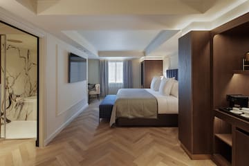 a room with a bed and a tv