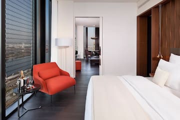 a bedroom with a bed and a chair