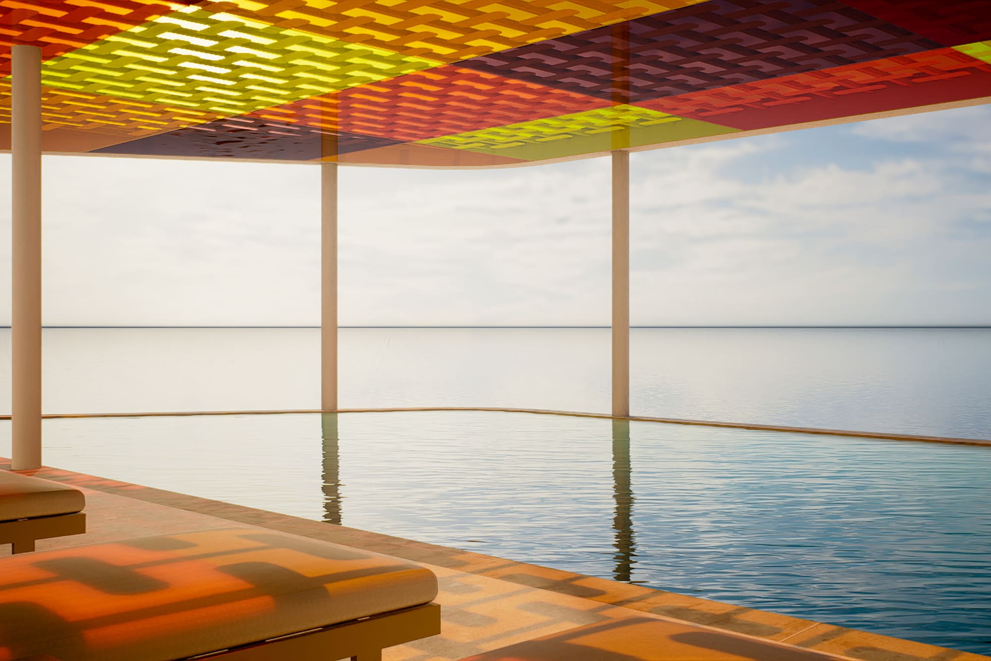 Colorful patterned canopy over oceanfront infinity pool and outdoor lounge.