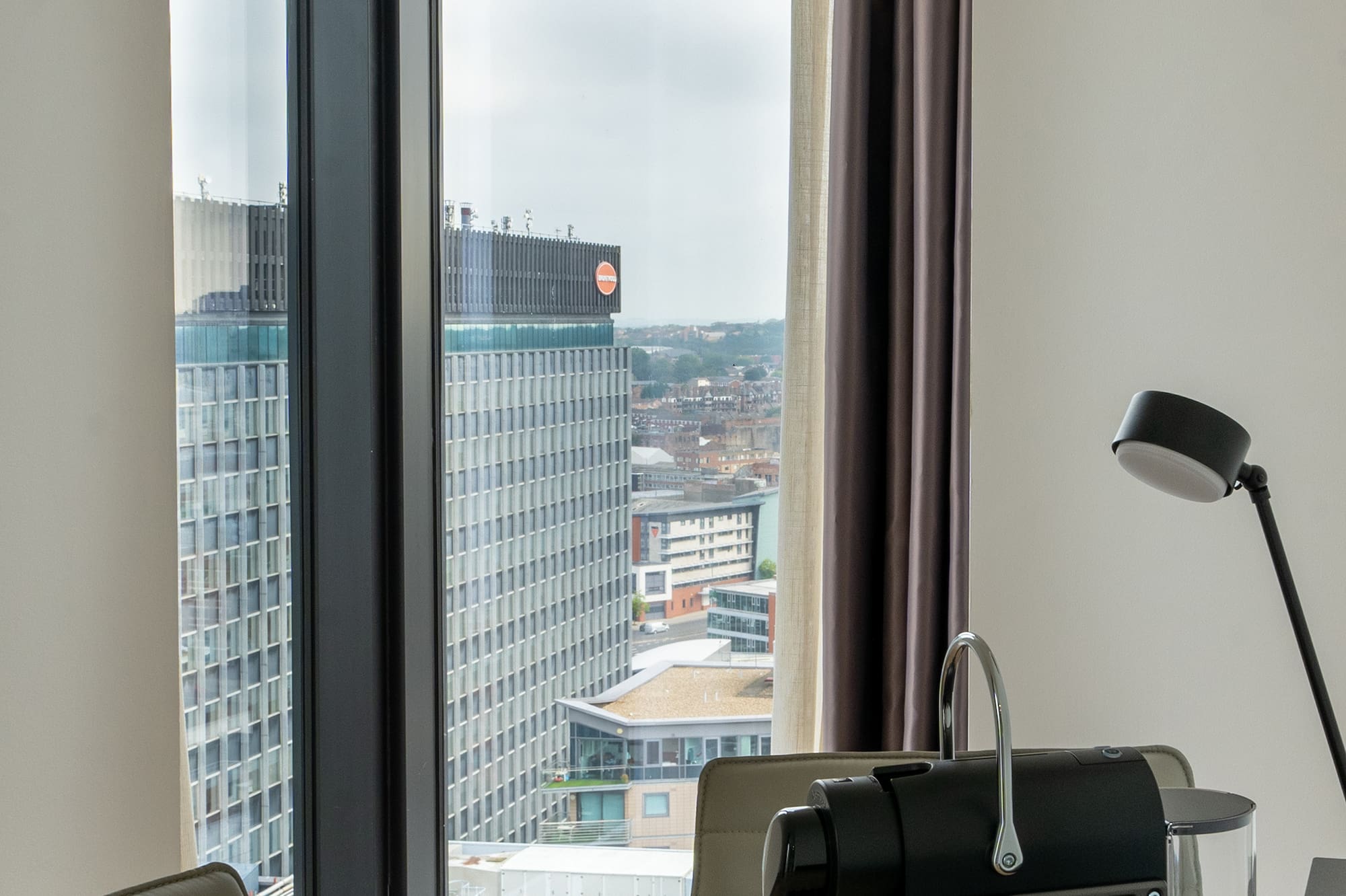 a coffee machine on a table with a window