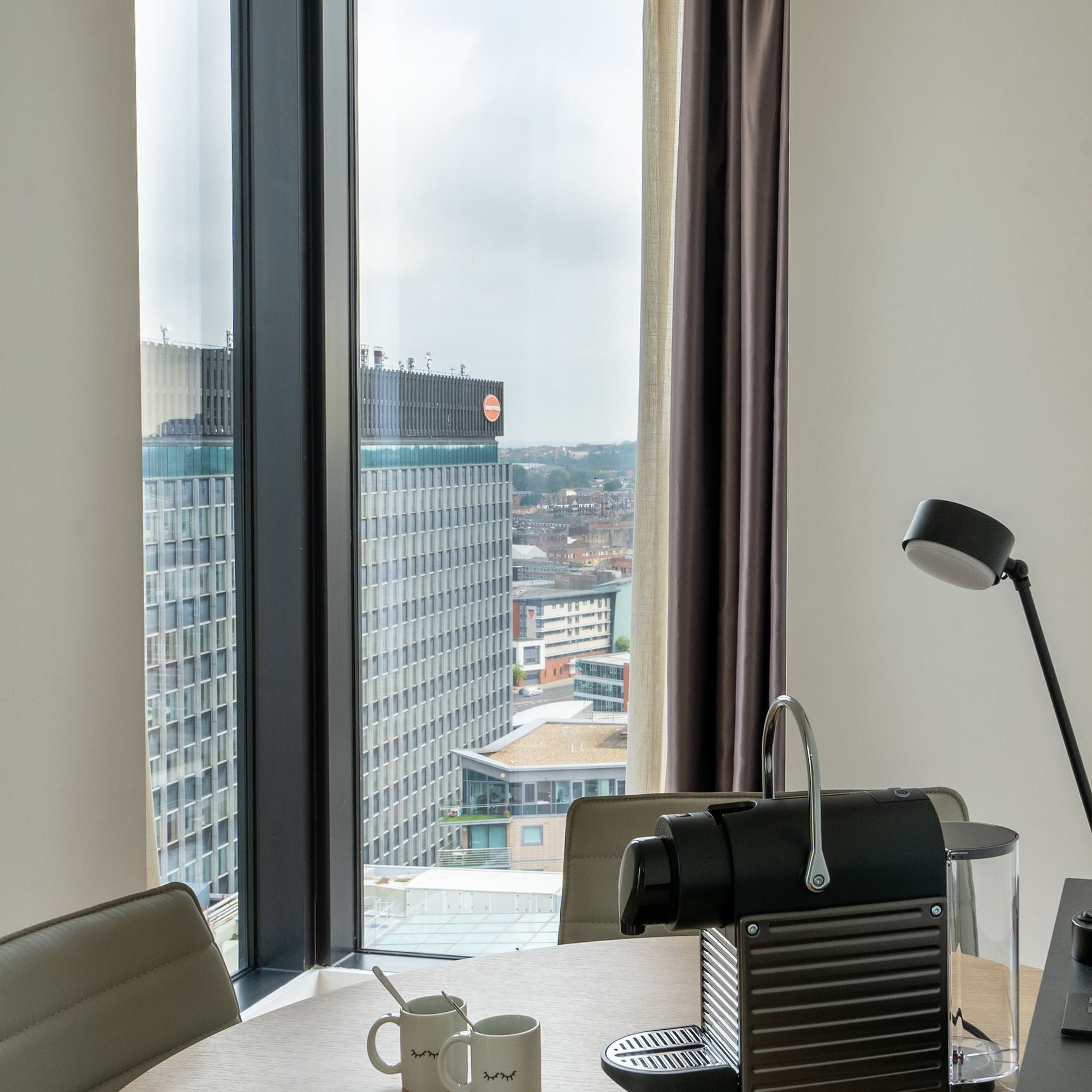 a coffee machine on a table with a window