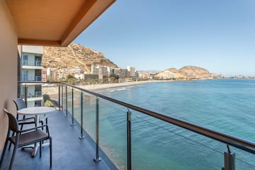 a balcony overlooking a beach and buildings