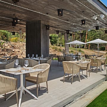 a patio with tables and chairs