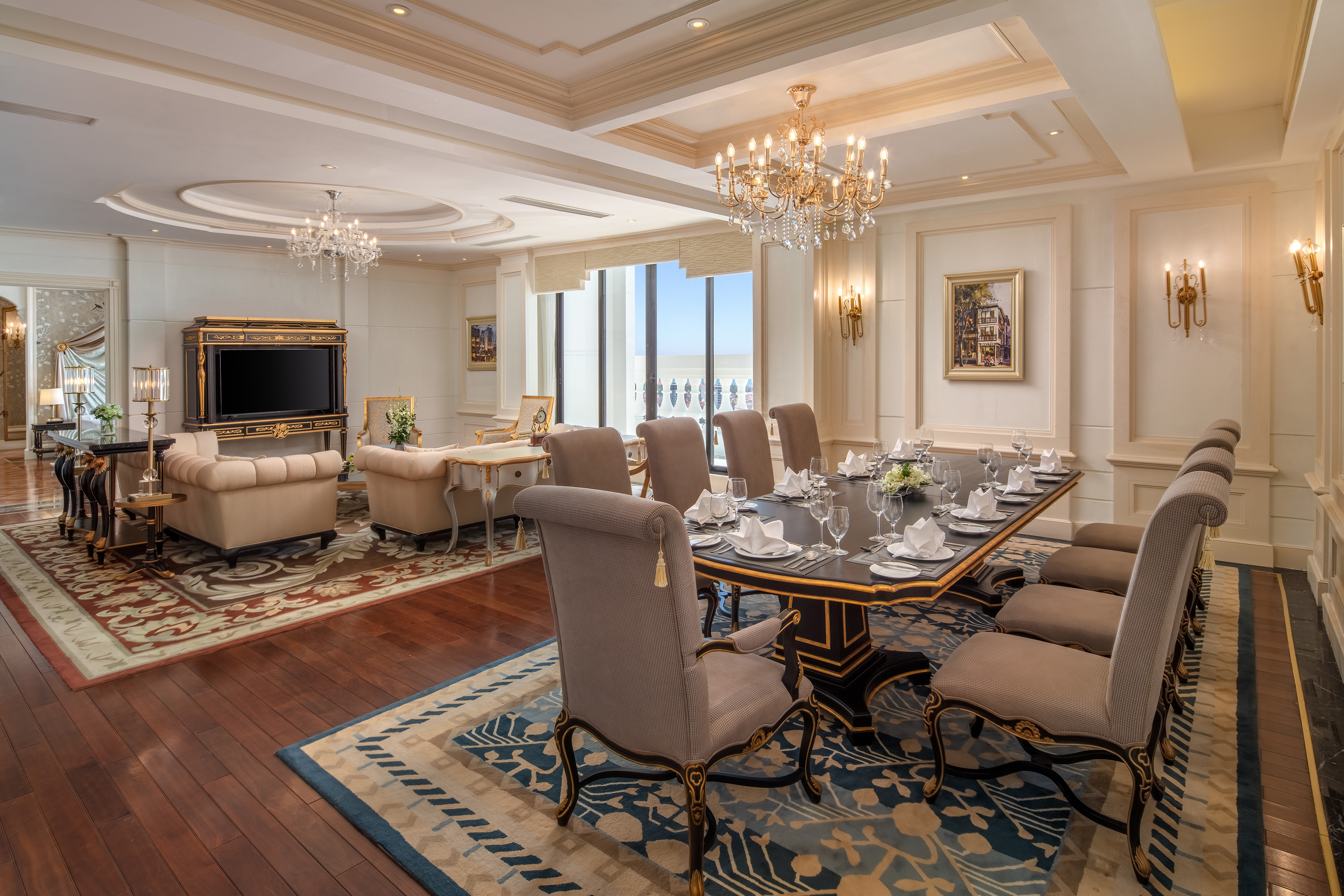 Luxury hotel dining and living room suite with elegant decor, ocean view.