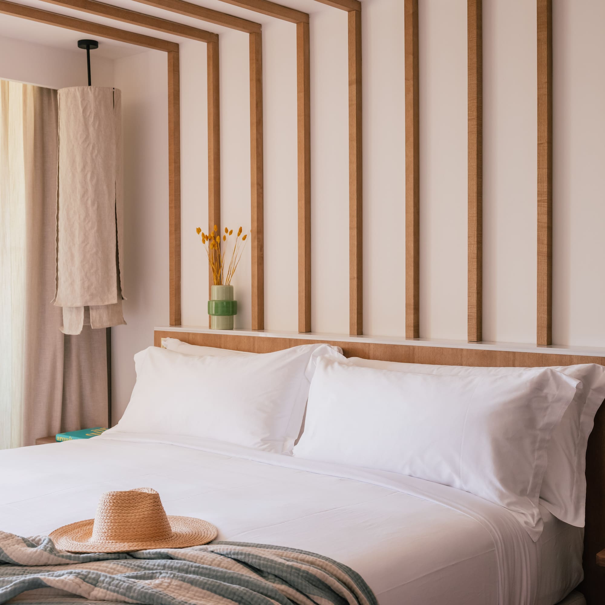 a bed with a hat on it