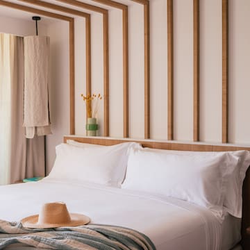 a bed with a hat on it