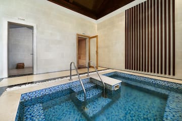 a swimming pool with stairs and a door