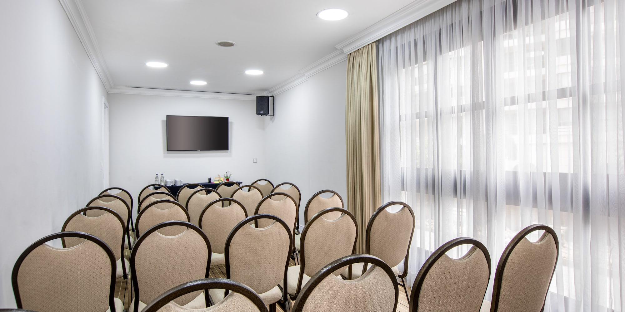 a room with chairs and a television