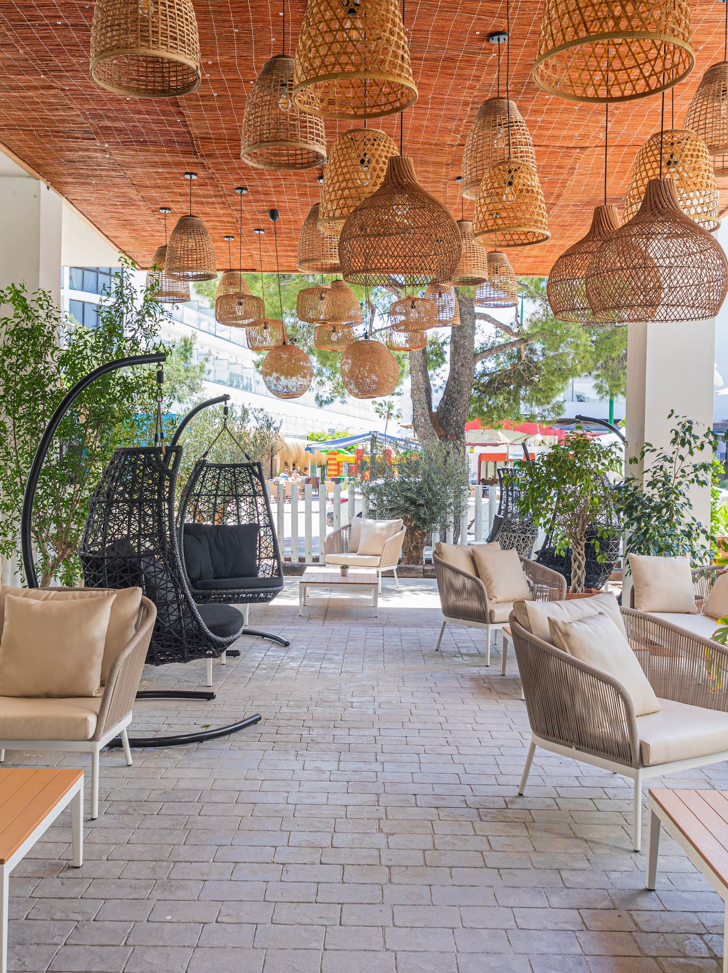 a patio with wicker chairs and tables