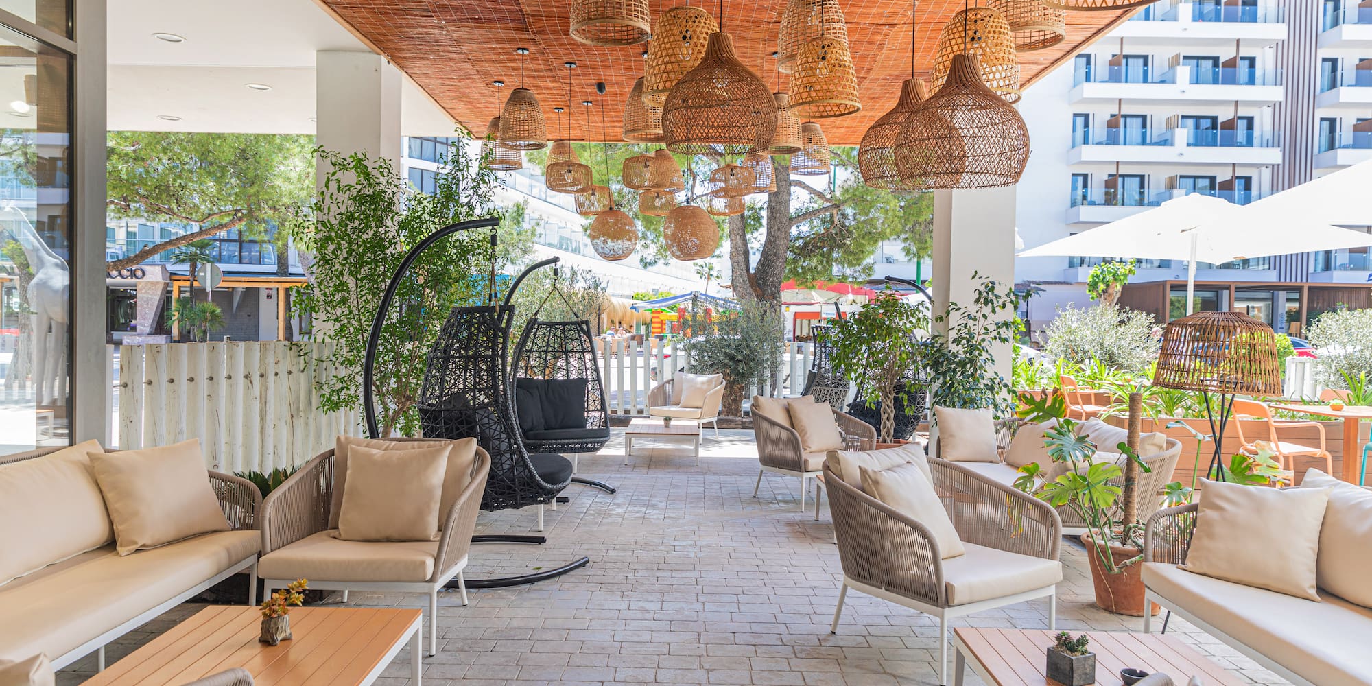 a patio with wicker chairs and tables