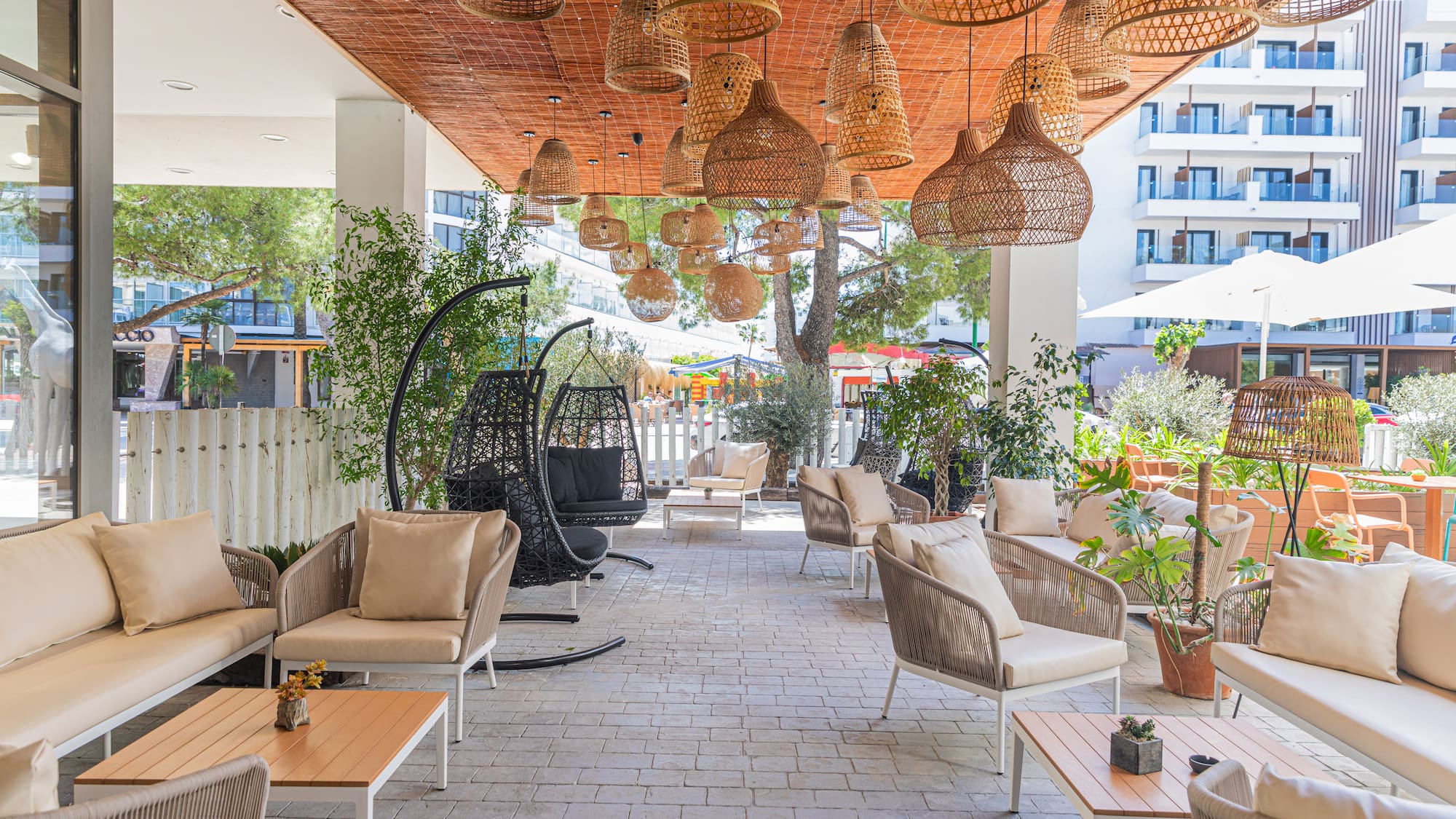 a patio with wicker chairs and tables