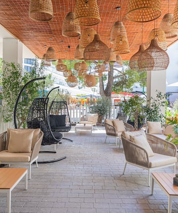 a patio with wicker chairs and tables