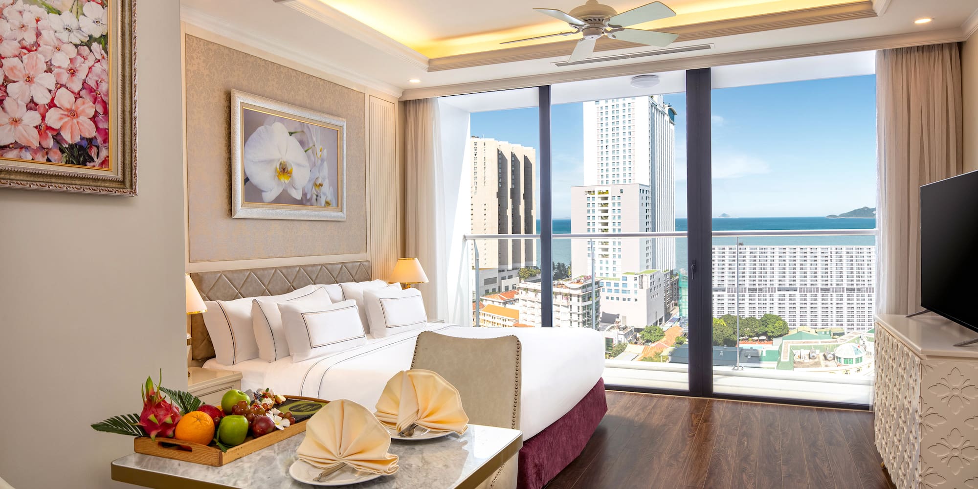 a room with a bed and a table with fruit on it