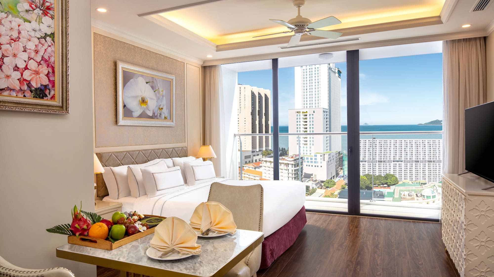 a room with a bed and a table with fruit on it