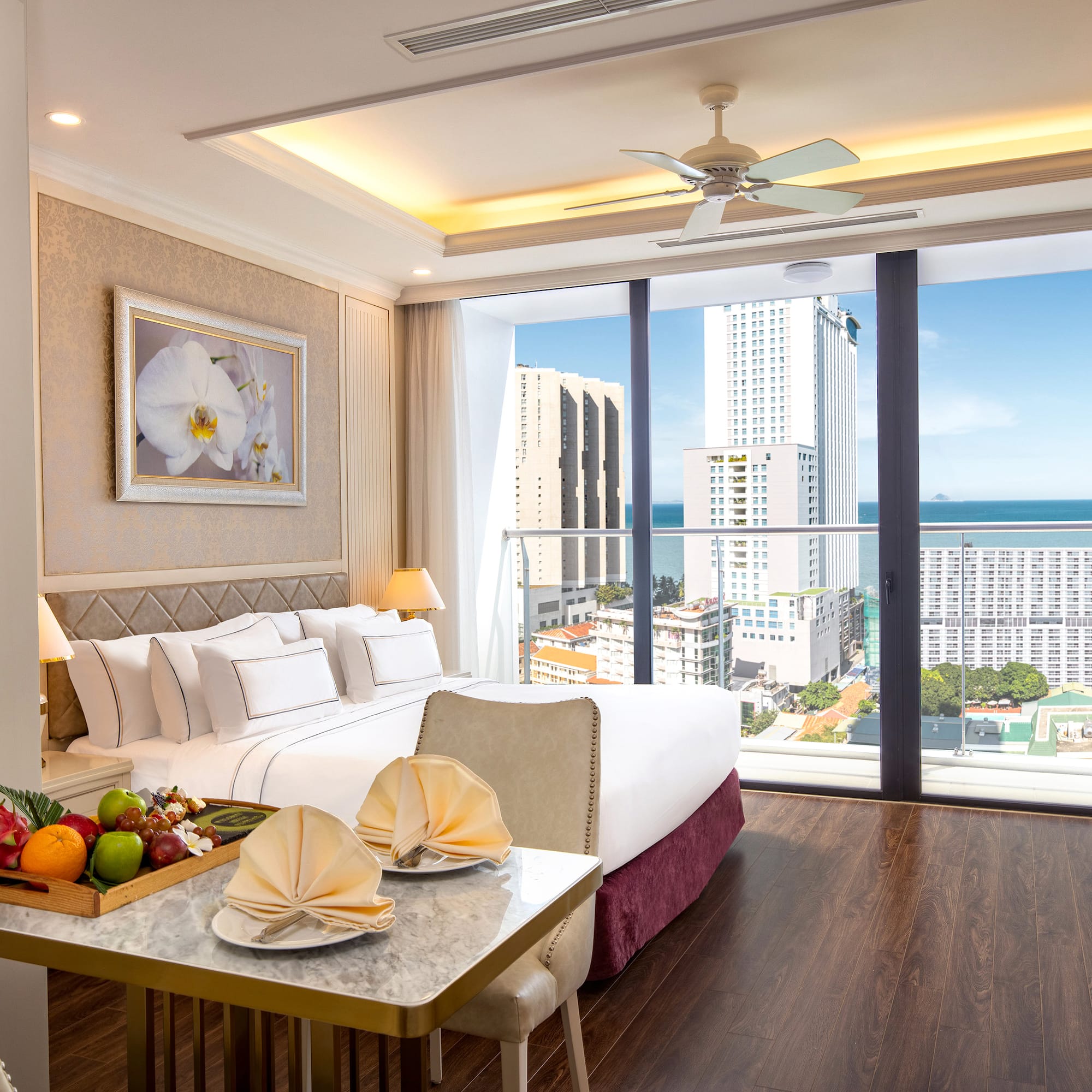 a room with a bed and a table with fruit on it