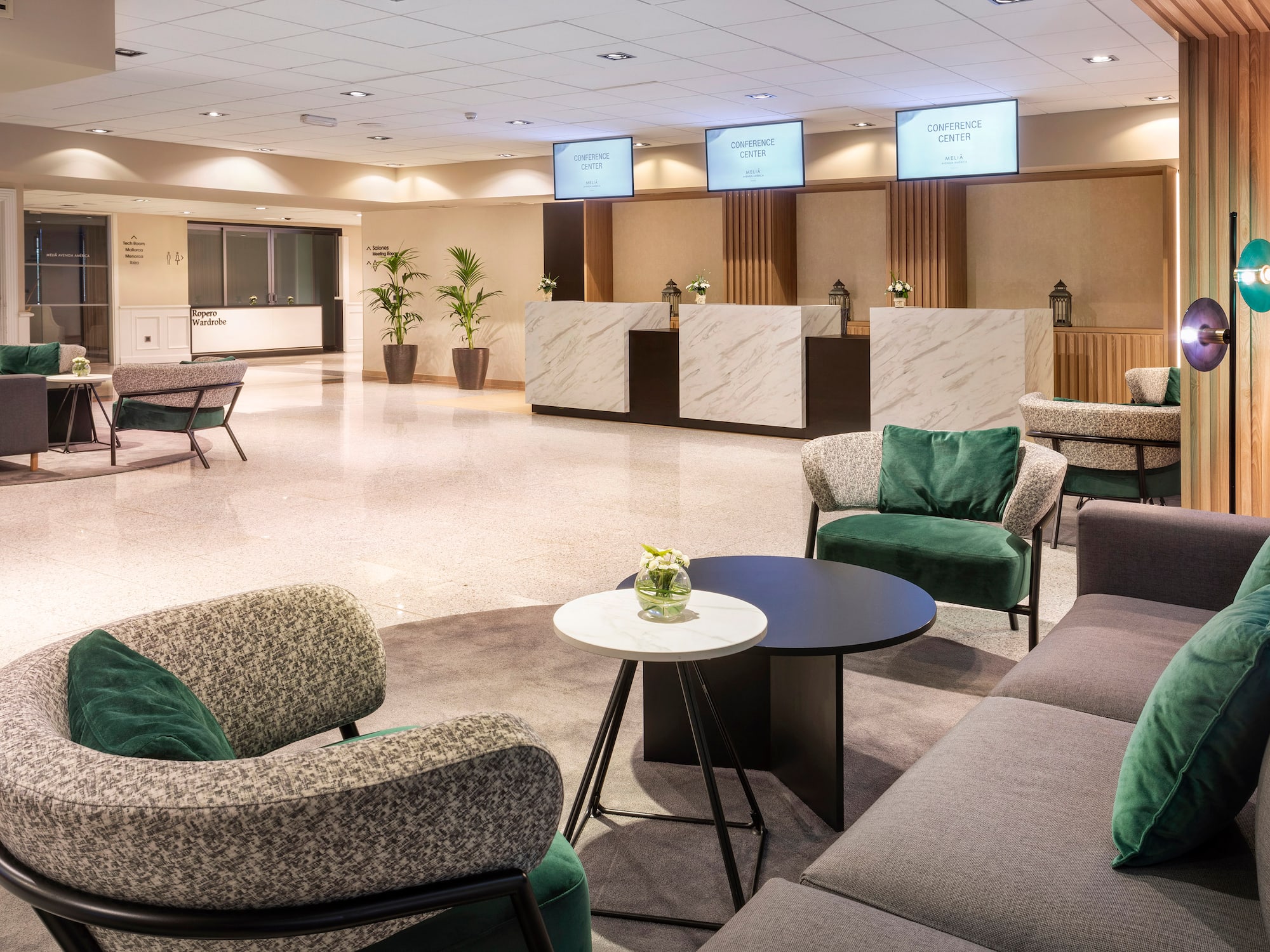 a room with a reception desk and chairs