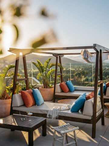 a patio with a view of a valley and mountains