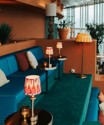 a room with a couch and a couch with lamps