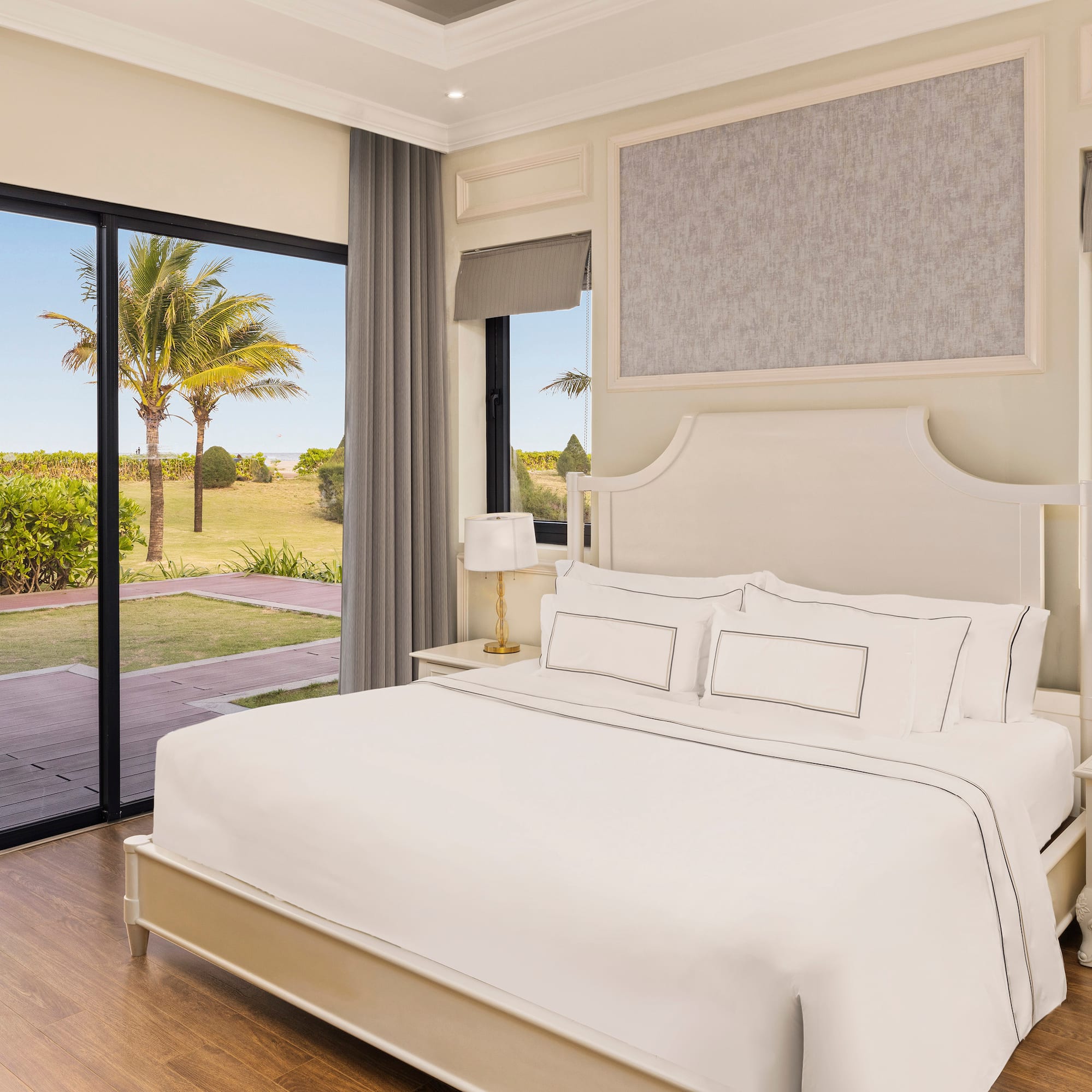 a bedroom with a large bed and glass doors