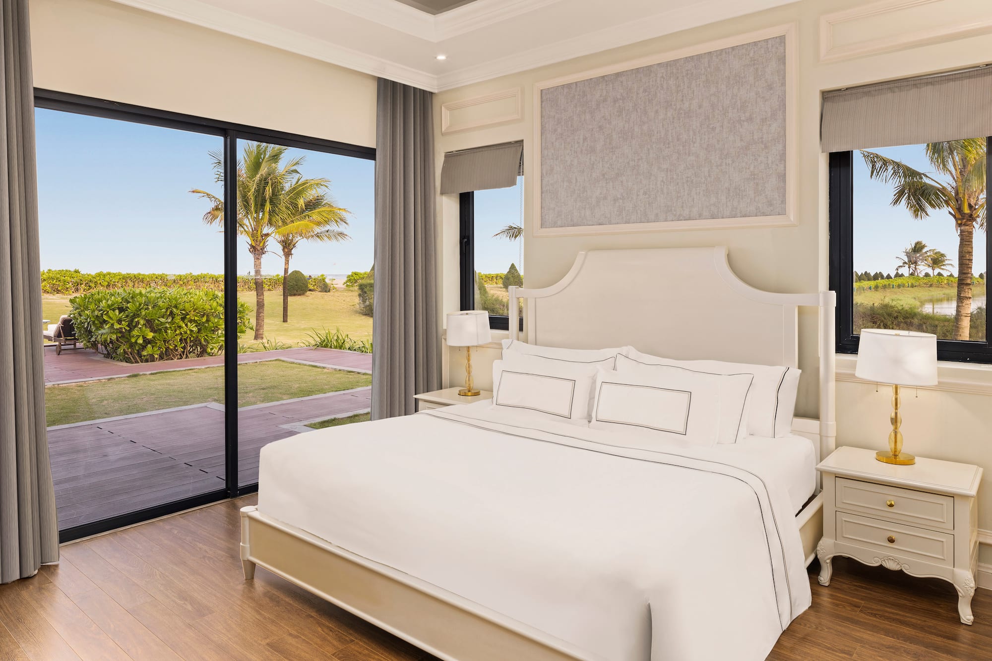 a bedroom with a large bed and glass doors