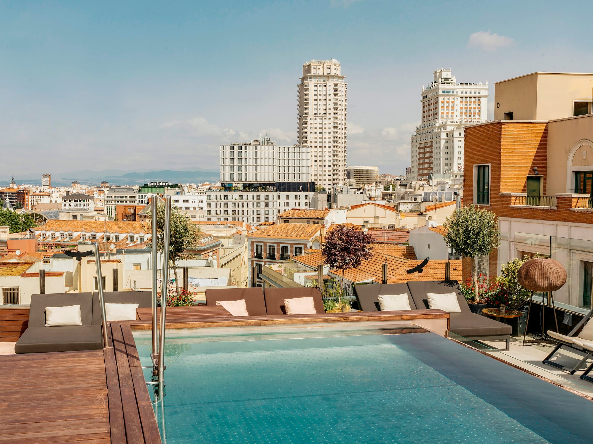 a pool on a rooftop overlooking a city