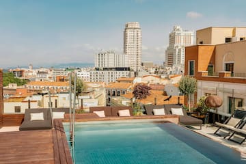 a pool on a rooftop overlooking a city