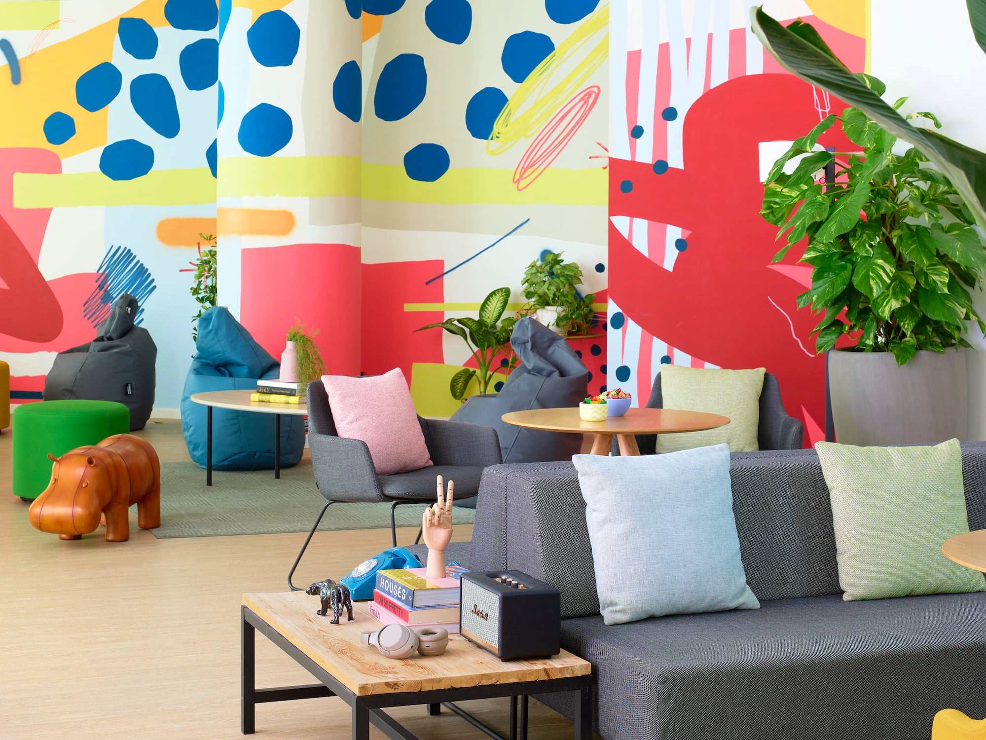 a room with colorful wall and couches