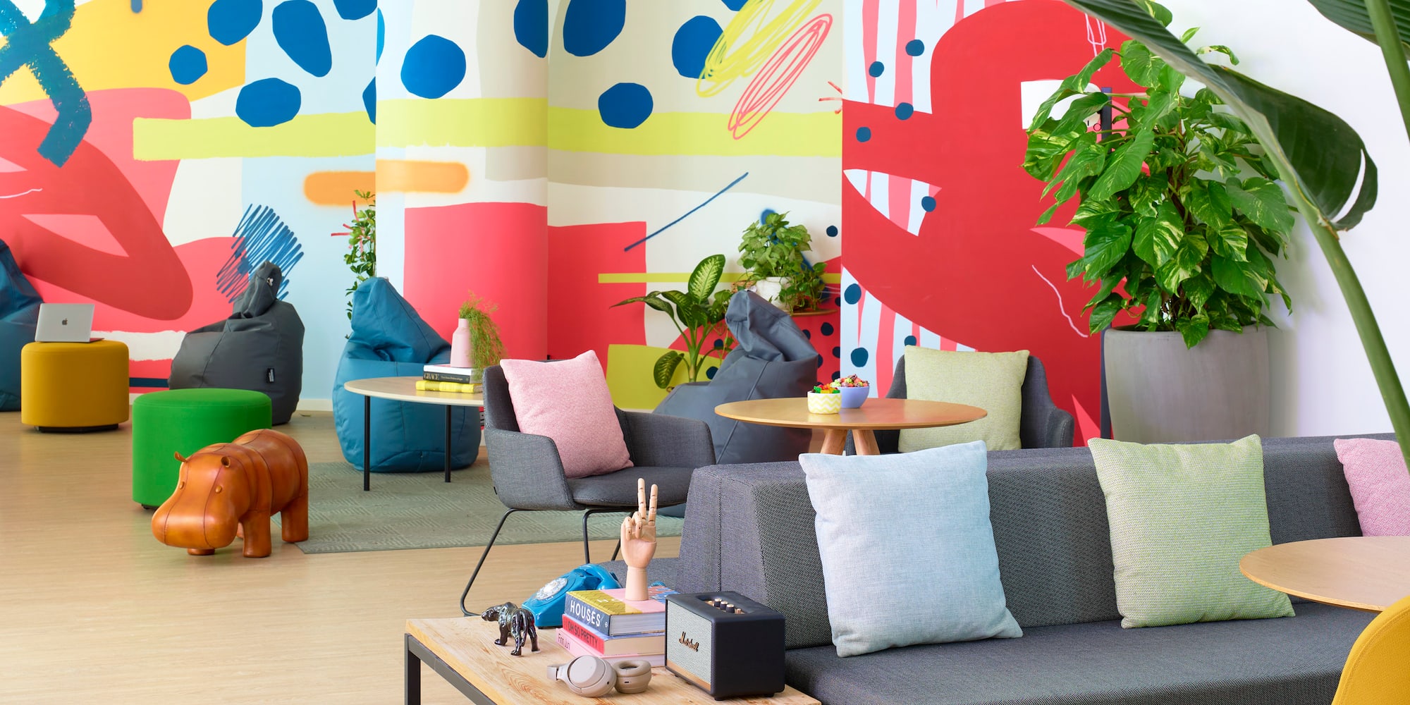 a room with colorful wall and couches