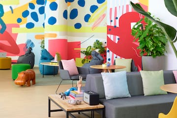 a room with colorful wall and couches