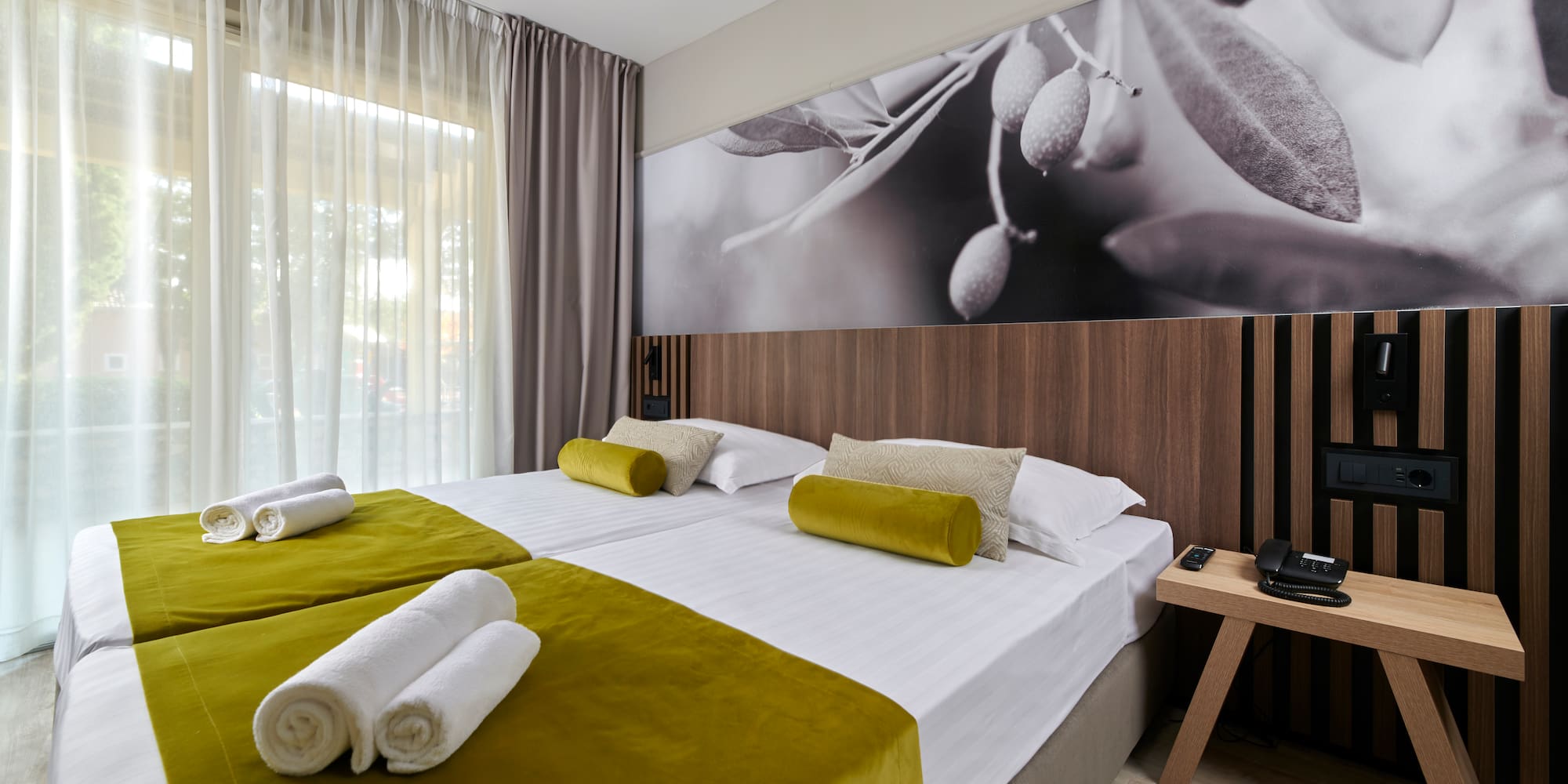 a room with a bed and a picture of olives