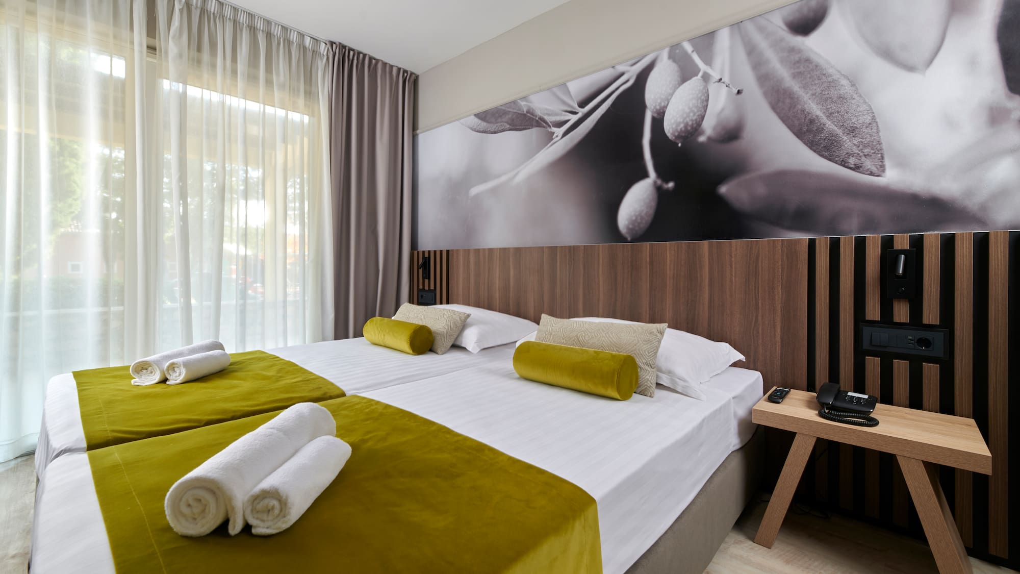 a room with a bed and a picture of olives