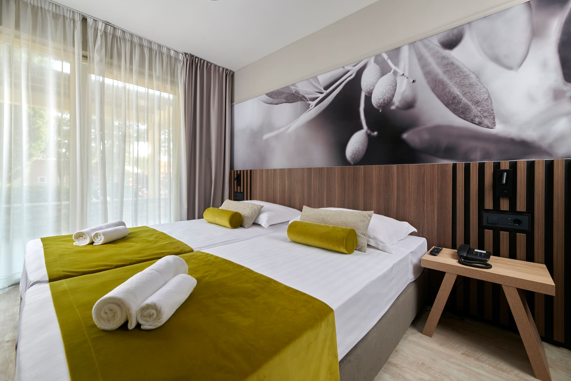 a room with a bed and a picture of olives