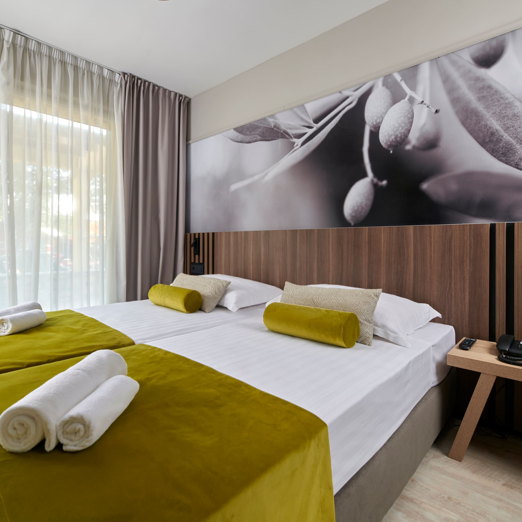 a room with a bed and a picture of olives