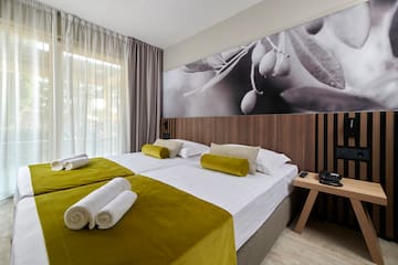 a room with a bed and a picture of olives