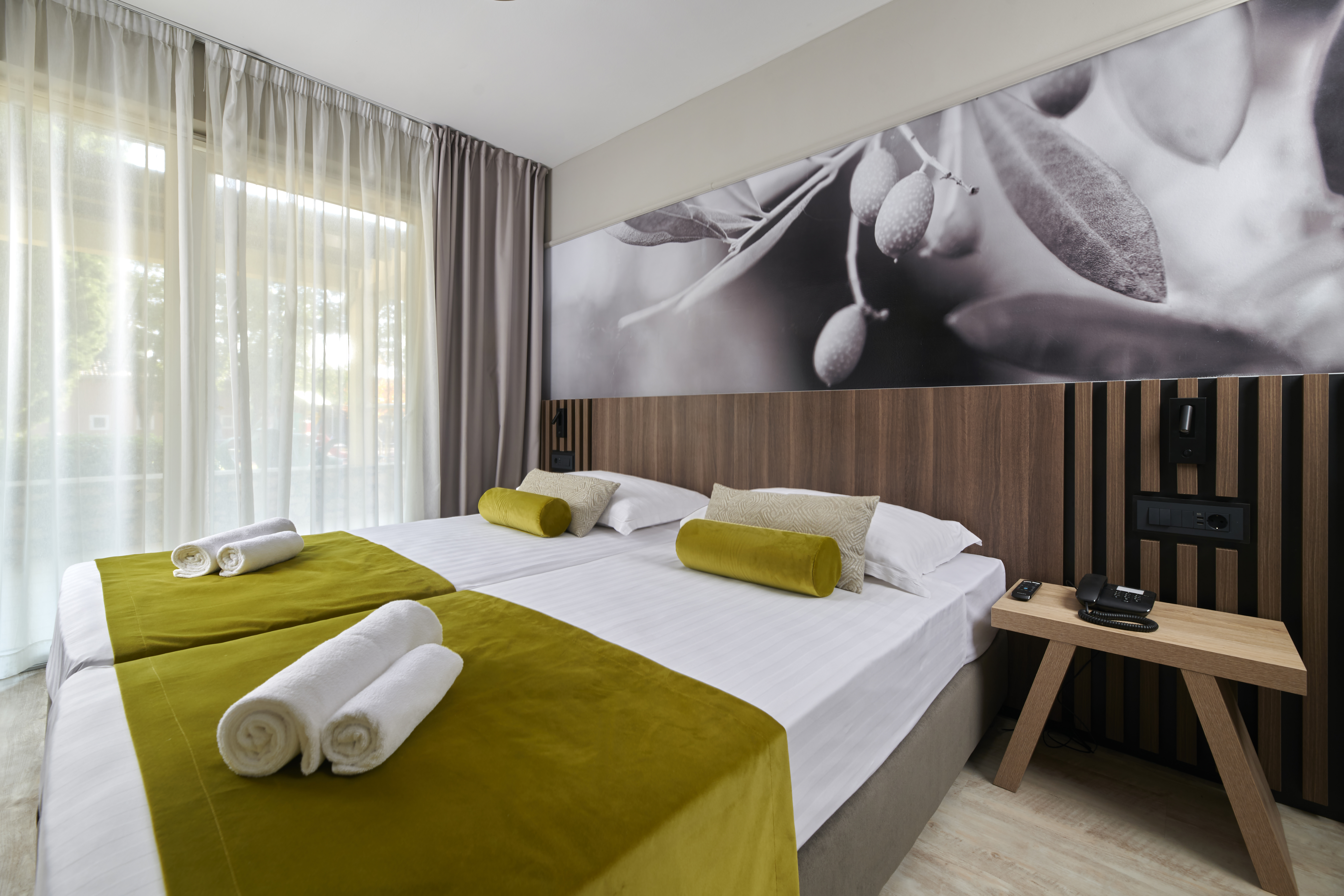 a room with a bed and a picture of olives