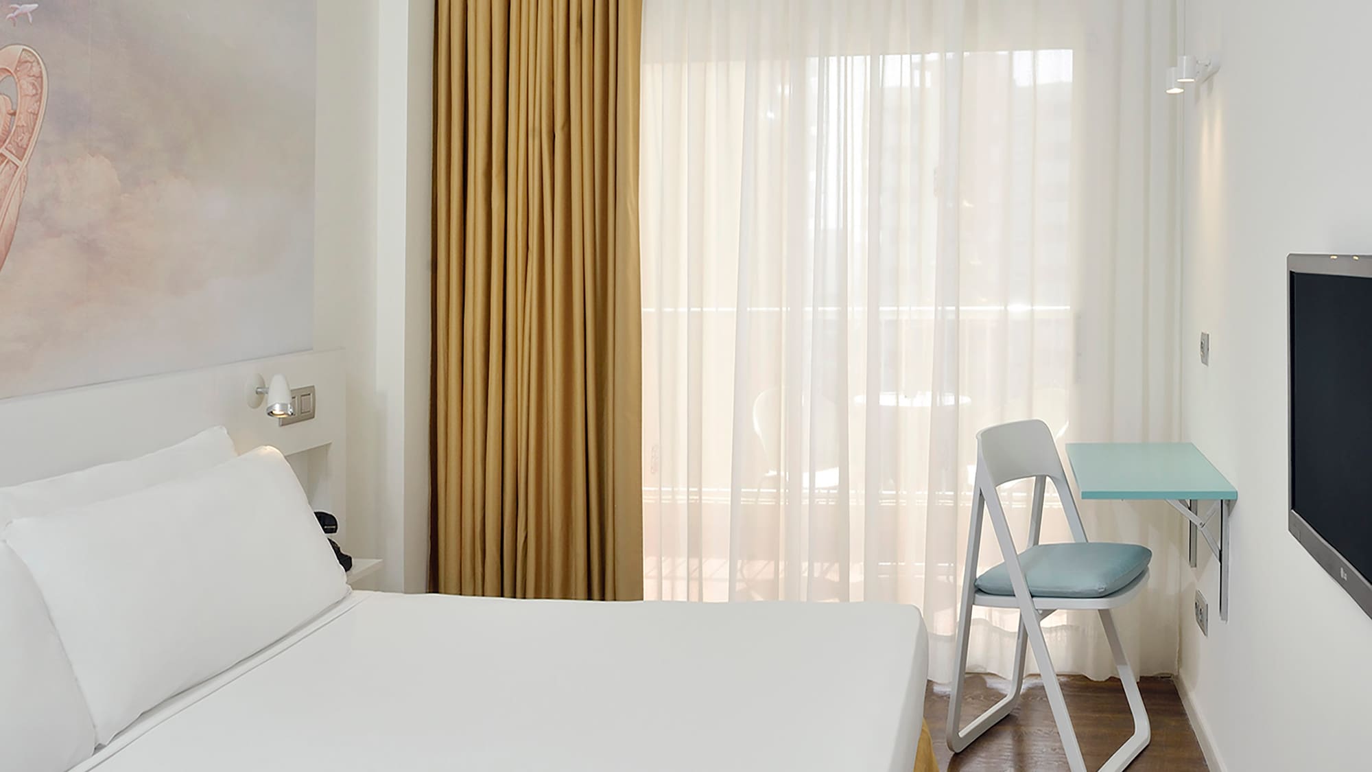 a room with a bed and a tv