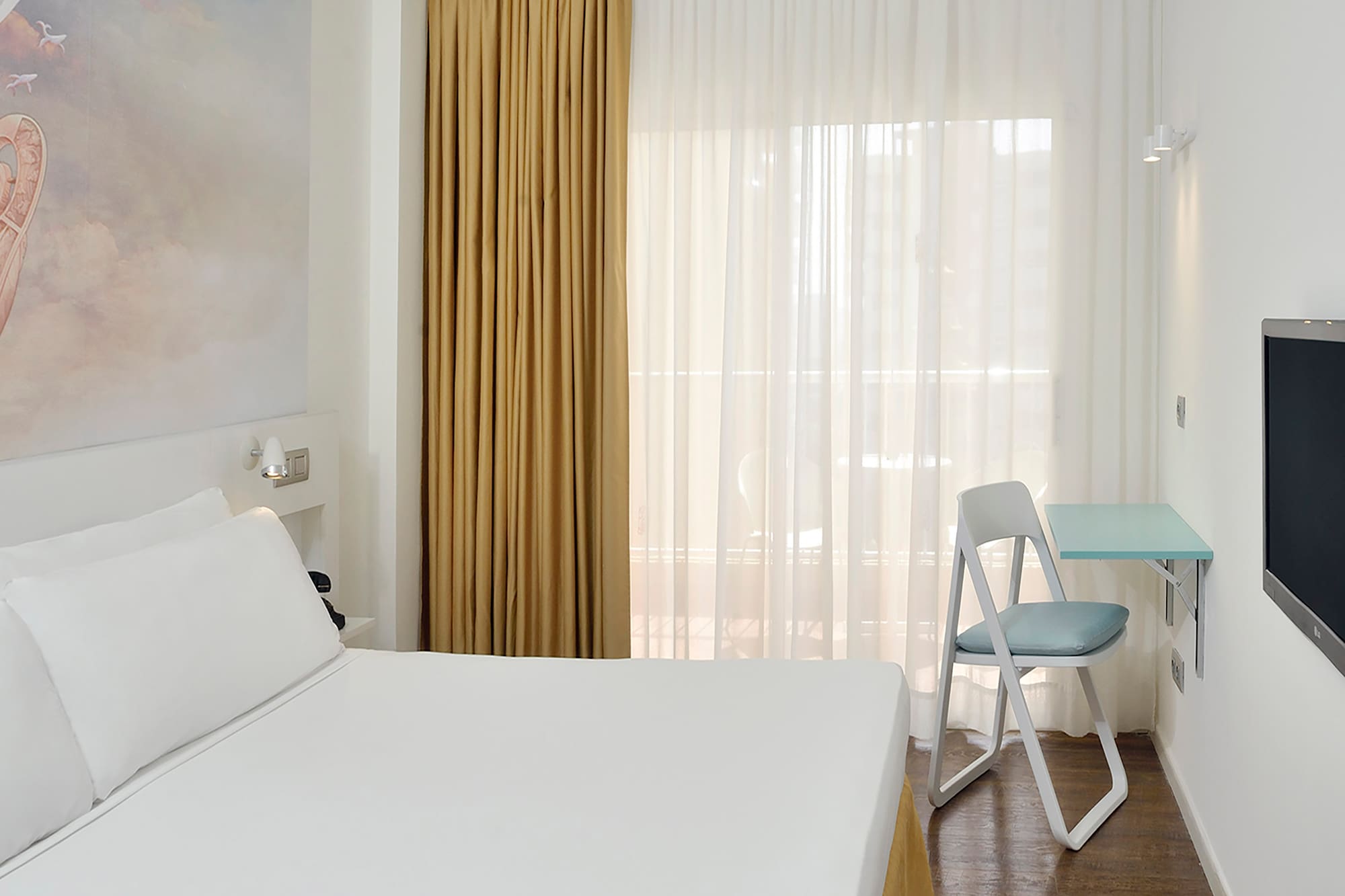 a room with a bed and a tv