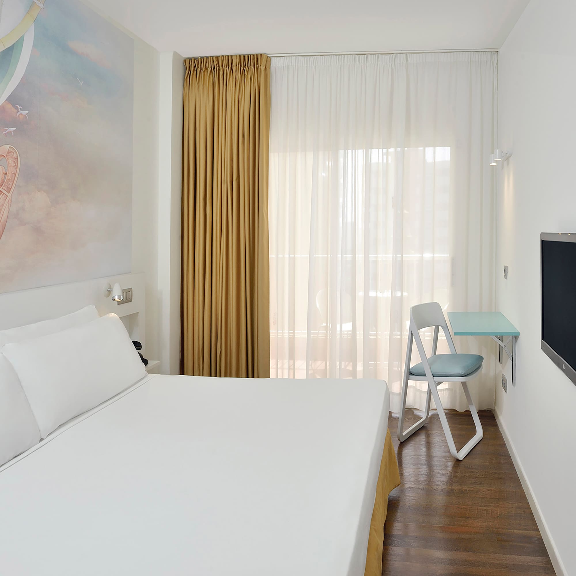a room with a bed and a tv