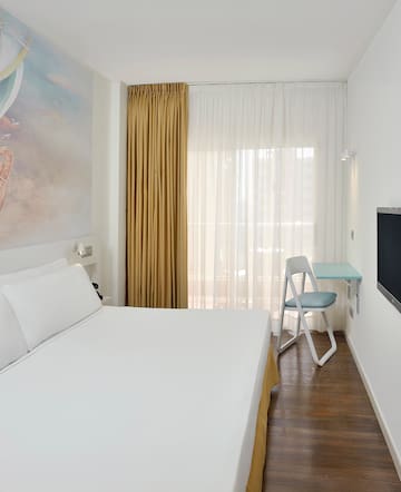 a room with a bed and a tv