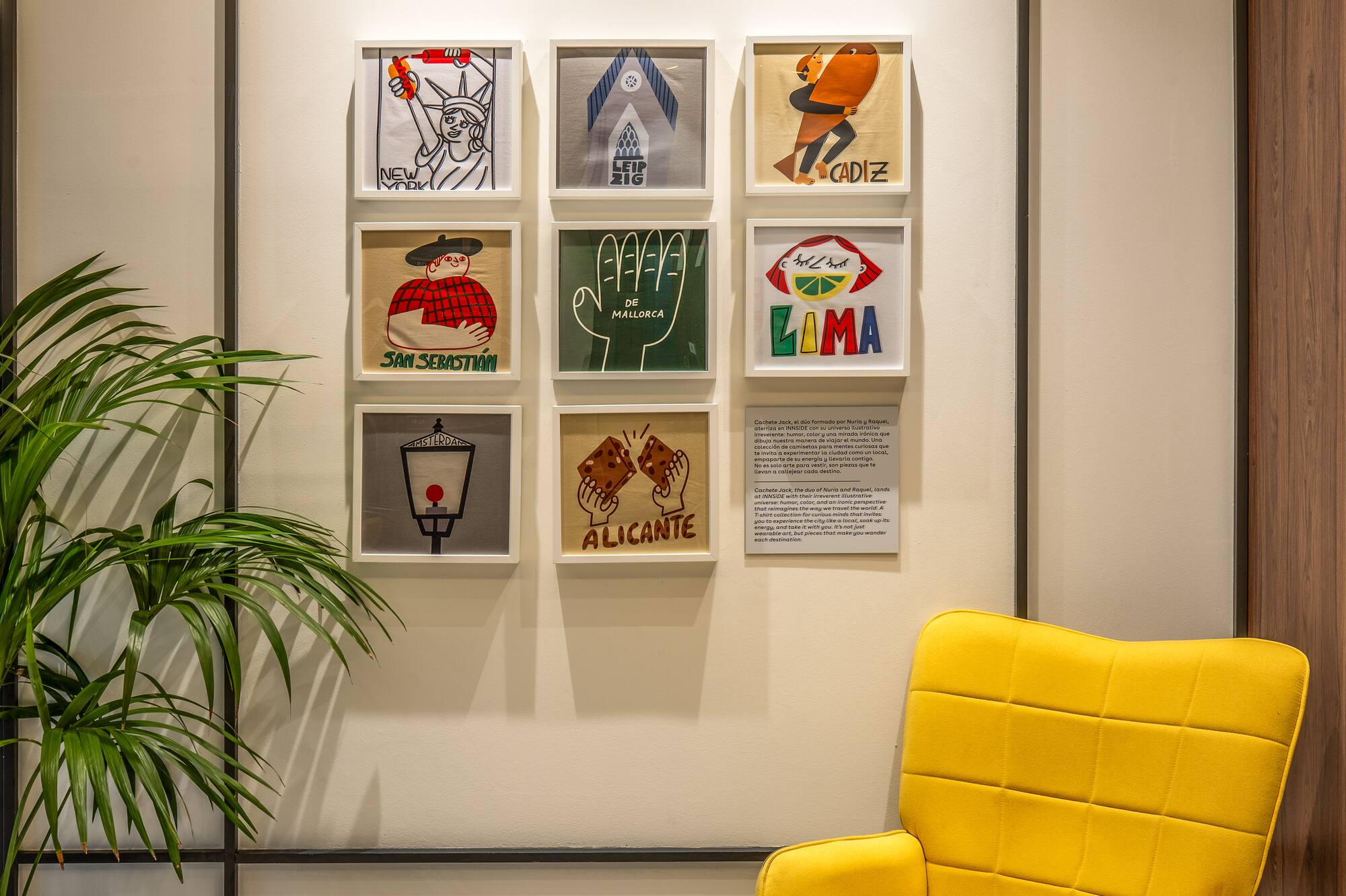 Modern interior with yellow armchair, plant, and gallery wall of travel city art.