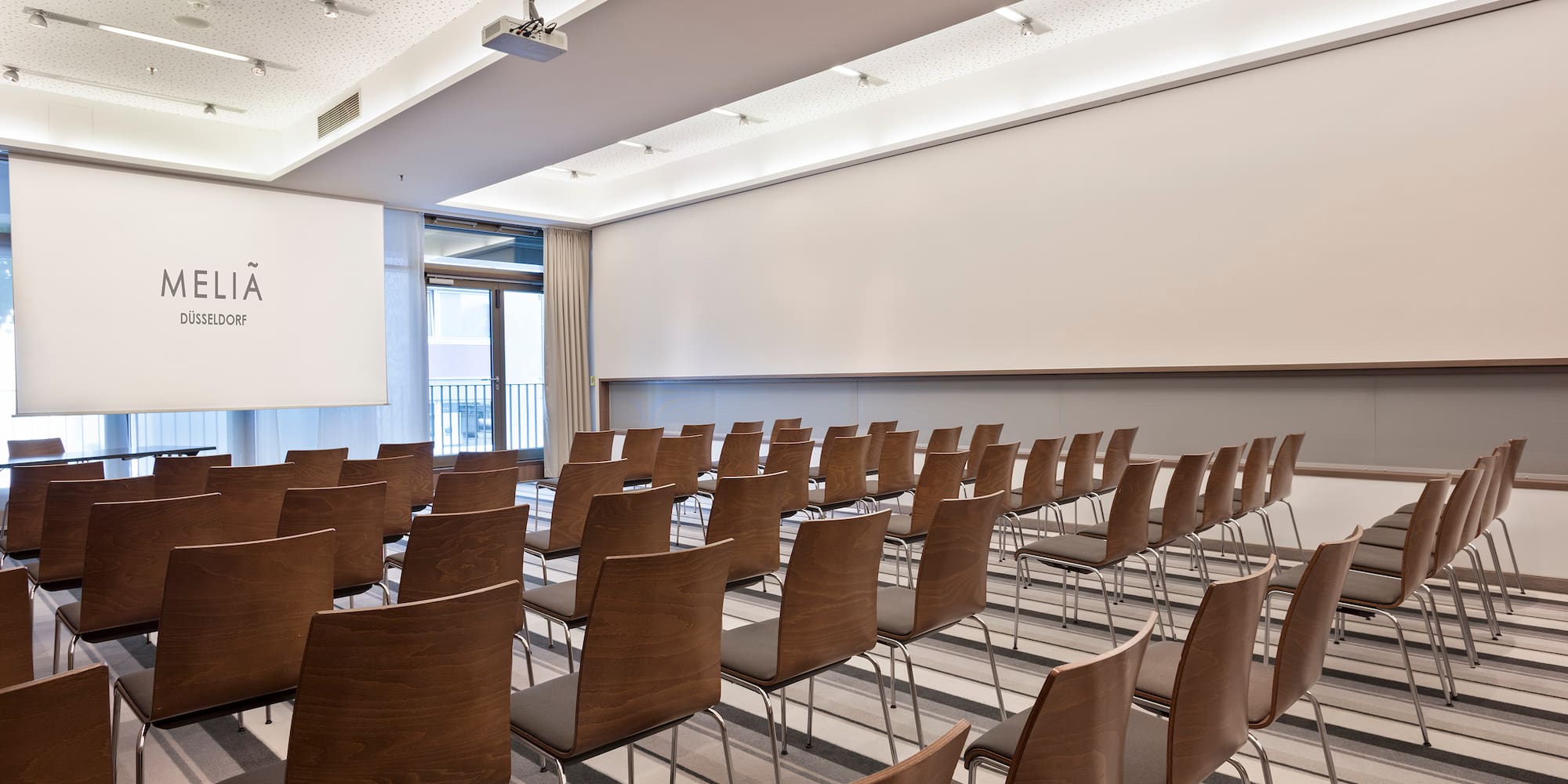 a room with chairs and a projector screen