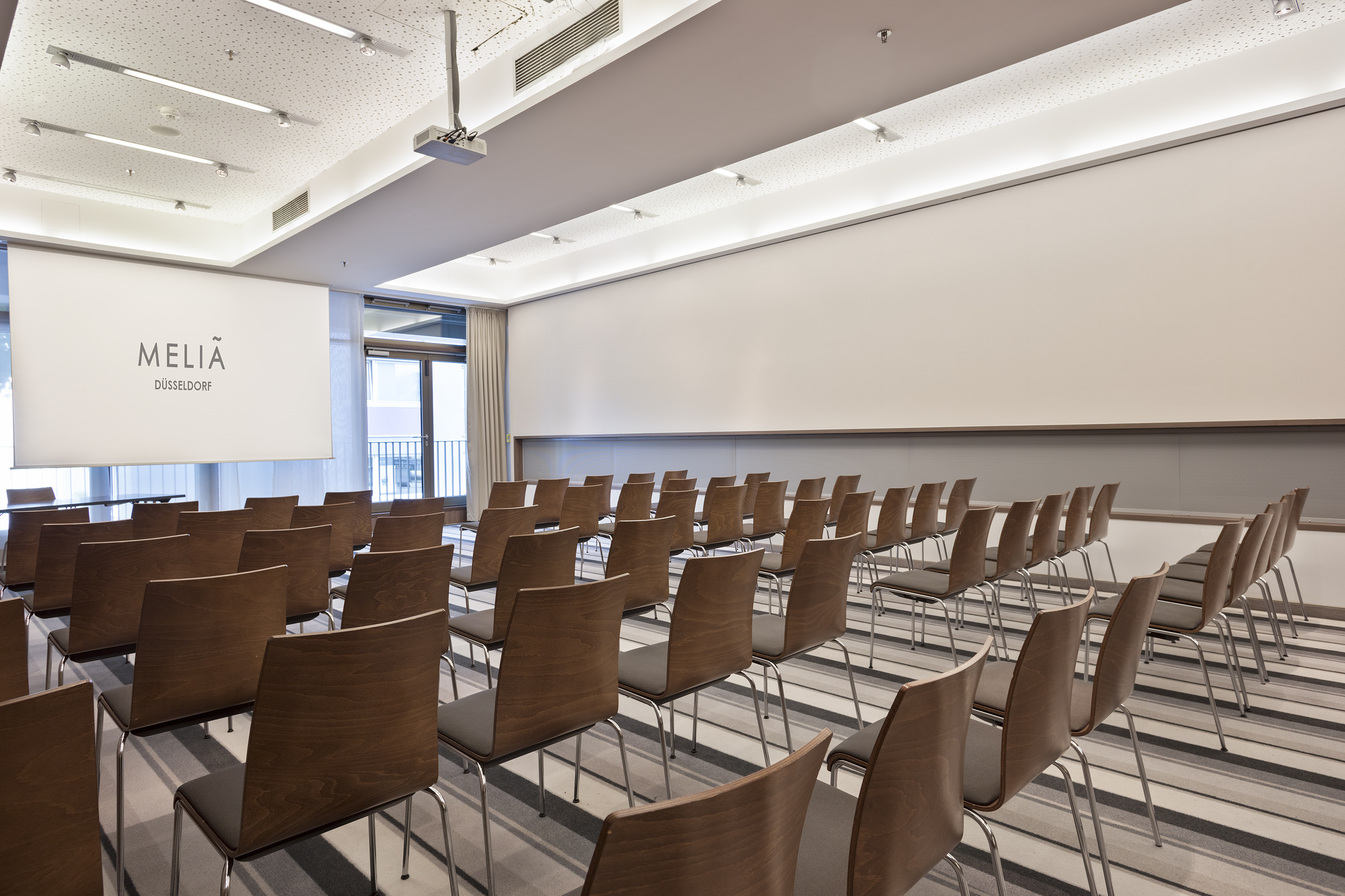 a room with chairs and a projector screen
