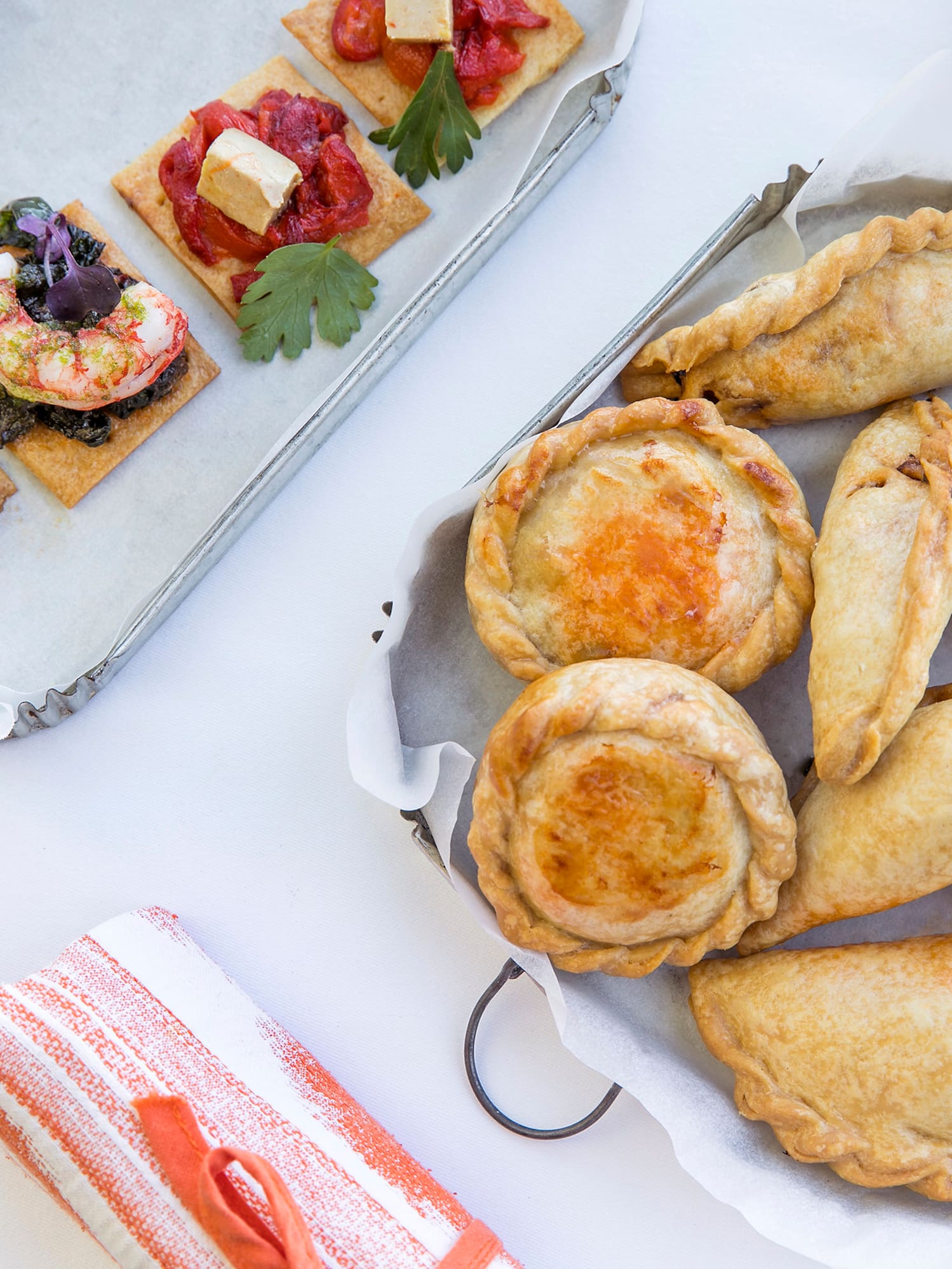 a tray of pastries and a plate of food